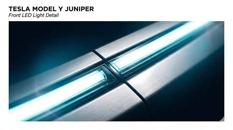 테슬라 모델Y 주니퍼의 전면 풀-width LED 라이트바 매크로 클로즈업으로 차체 폭 전체를 가로지르는 연속된 조명 시그니처와 정밀한 패널 간격이 보이는 디테일 샷